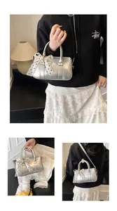 Detail of silver handbag featuring a polka dot ribbon bow and detachable shoulder strap