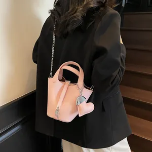 Pink lychee texture leather bucket bag with silver chain strap and padlock detail