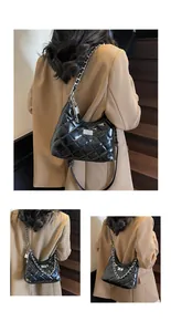 Detail of quilted leather bag featuring silver chain strap and metallic twist lock closure