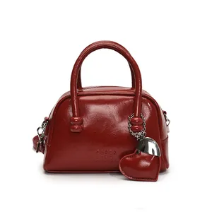 Retro burgundy patent leather Boston handbag with heart charm and silver metal accents