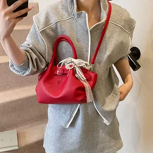 Red lychee grain leather handbag with pearl and lace bow pendant for 2025 fashion