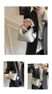 Silver wrinkled leather square bag with heart charm and detachable shoulder strap