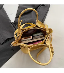 Top view of yellow lychee leather bucket bag showing large capacity interior compartment
