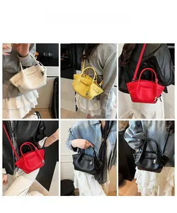 Detail view of mini bucket bag in multiple colors with metallic ball pendant