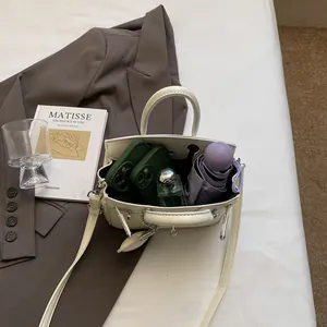 Chic cream leather mini kelly handbag with spacious interior for phone and accessories