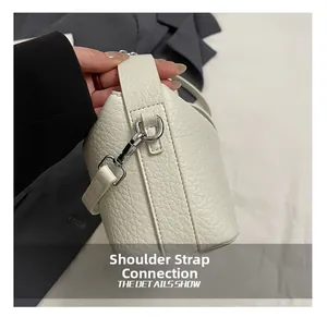 Detail showing high-quality pebble grain leather texture and metal shoulder strap buckle