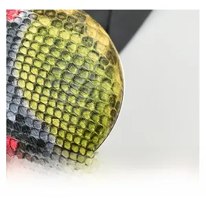 Close-up of vibrant snake skin pattern texture on women's handbag with scale details