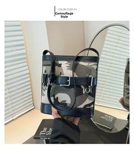 Detailed front view of camouflage canvas bucket bag with black leather trim and metal buckle