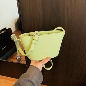 Women Minimalist PU Leather Lychee Pattern Mini Bucket Crossbody Bag With Metal Heart Pendant Knot Strap Fashion Shoulder Bag
