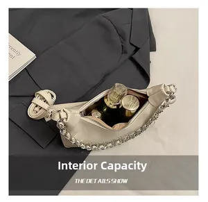 Internal capacity of large crescent tote bag with cosmetics inside a silver-toned bag