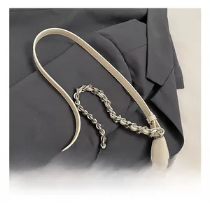 Close-up of beige tote bag showing dual leather straps and silver metal chain detail