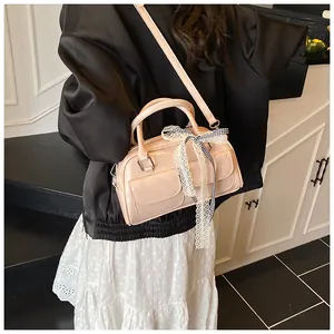 Pink bow shoulder bag with lace details shown on a model for casual daily outfit style