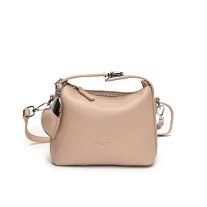 Minimalist beige lychee grain crossbody bag with silver hardware and heart charm decor