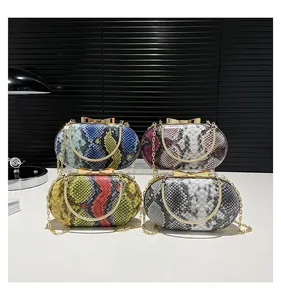 Detail of four snake pattern clutch bags with bow clasps and gold chain straps