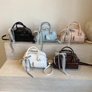 Bow tie hobo bag with top handle in five colors including black pink and blue