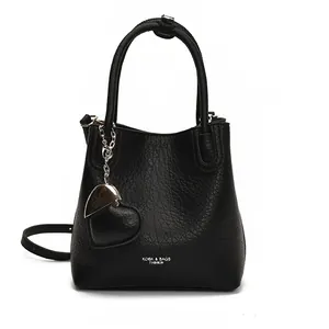 Litchi pattern black bucket bag with cylindrical handles and heart-shaped charm