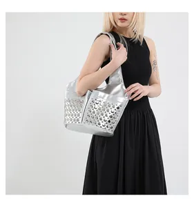 Detail shot of silver metallic tote bag with rivet studs and integrated wide shoulder strap