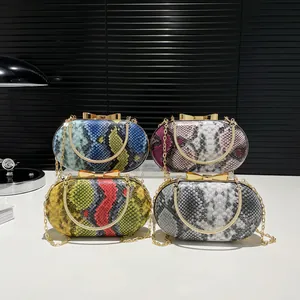 Retro snakeskin textured clutch purses with bow-shaped gold clasp and chain straps
