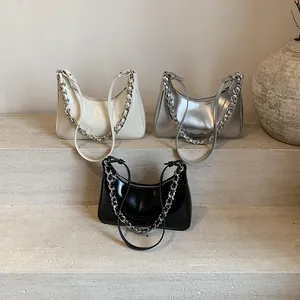Minimalist crescent tote bag in silver, cream, and black with metallic chain details