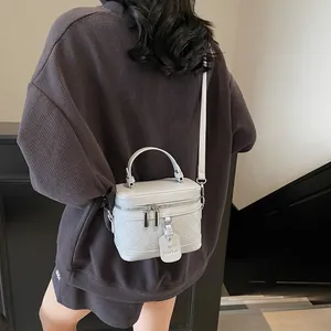 Quilted beige box bucket bag with top handle and adjustable shoulder strap for women