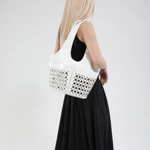 White rivet tote bag with polished finish and large capacity for women in modern chic style
