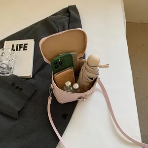 Pink quilted bucket bag with crossbody strap showing spacious interior capacity