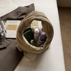 Minimalist beige quilted puffer bag showing large storage capacity for daily essentials