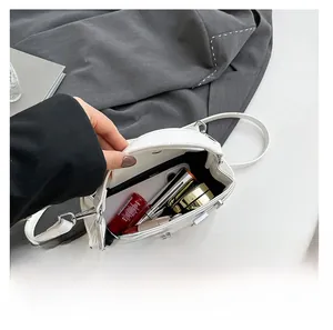 Interior view showing the spacious capacity of this white leather crossbody bag for women