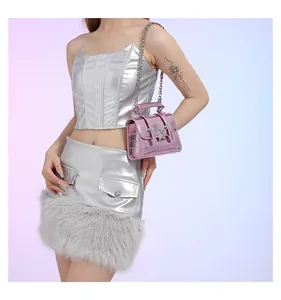 Rosafarbene Metallic-Umhängetasche mit Sternschnalle und Kette an einem Y2K-Modell