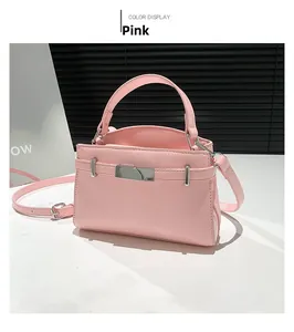 Detailed view of pink shoulder bag with pleated texture and silver metal clasp lock
