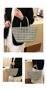 Detailed weave of a sage green hollow hand-woven tote bag with structured dual handles