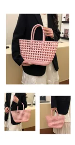 Detail of pink woven jelly basket bag showing hollow grid texture and stylish handle