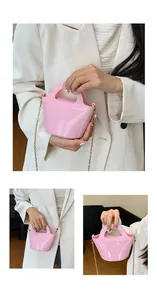 Macro detail of the bright pink jelly bag showing metallic chain and smooth PVC texture