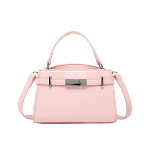 Pink Kelly style crossbody bag in glossy faux leather with silver buckle and top handle