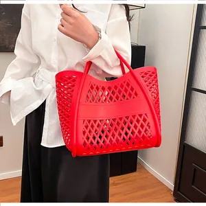 Detail of red hollow mesh tote bag showing the durable woven texture and sturdy handles