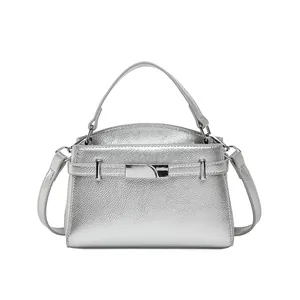 Silver mirror-finish leather tote bag with metallic buckle and detachable shoulder strap