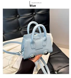 Detail view of a light blue mini crossbody bag with silver sphere base ornaments