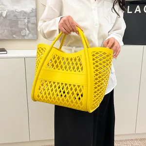 Modern bright yellow hollowed-out tote bag with geometric mesh design for casual wear