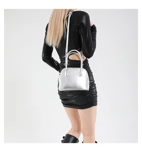 Sac bandoulière argenté avec sangle réglable présenté sur mannequin en studio