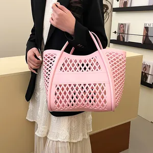 Pink hollowed-out cutout tote bag made of waterproof material for casual beach use