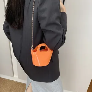 Vibrant orange mini jelly bucket bag with chain strap and round top handle