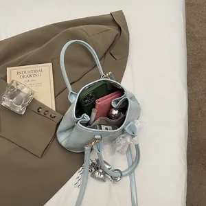 Light blue faux leather handbag with lace bow charm and silver heart detail