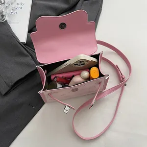 Pink cartoon bear small square bag showing spacious interior with daily essentials