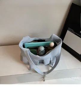 Top view of spacious interior of blue tote bag with tablet and folding umbrella inside