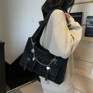 Black vintage shoulder tote bag with front pockets and metallic heart chain detail