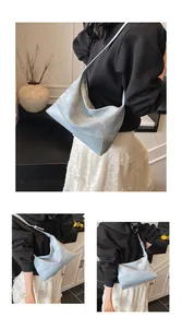 Detail view of light blue hobo bag with textured and smooth leather patchwork design