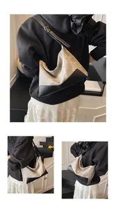 Detailed views of a minimalist grey canvas and black leather color-block shoulder bag
