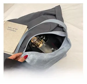 Internal view of light blue shoulder bag showing space for phone and cosmetics