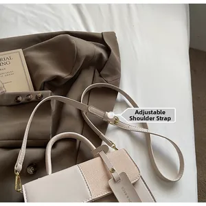 Detail of adjustable shoulder strap and beige contrast texture on retro crossbody bag