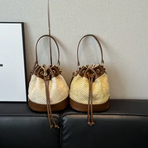 Chic woven straw bucket bags with brown leather trim in cream and yellow colors